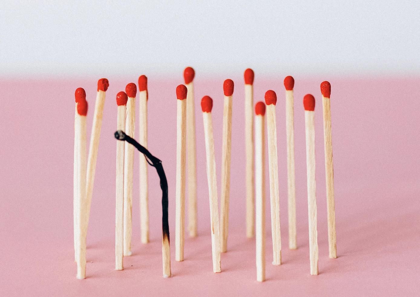 Matches lined up, one of them is fully burnt out