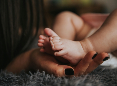 Hand holding baby's feet