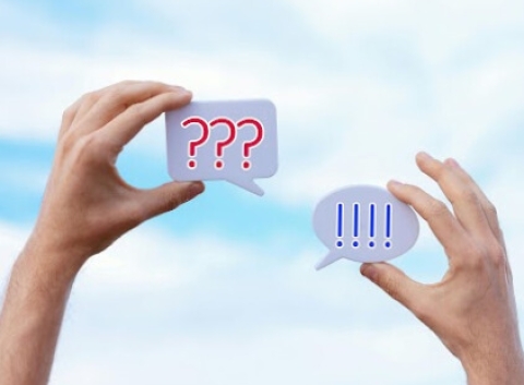 hands holding text bubbles saying "!!!" and "???"