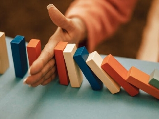 Woman playing with dominoes 